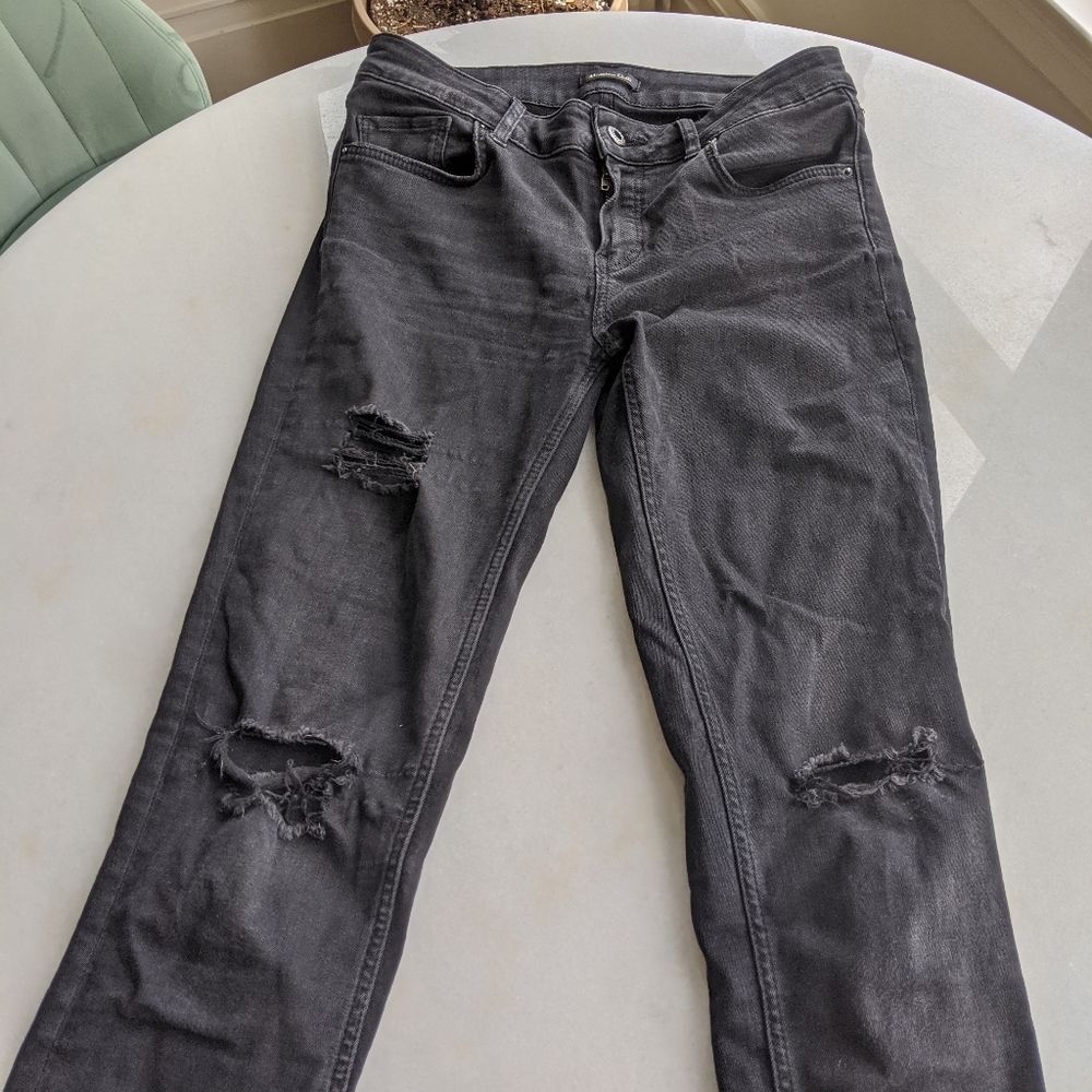Distressed black skinny jeans